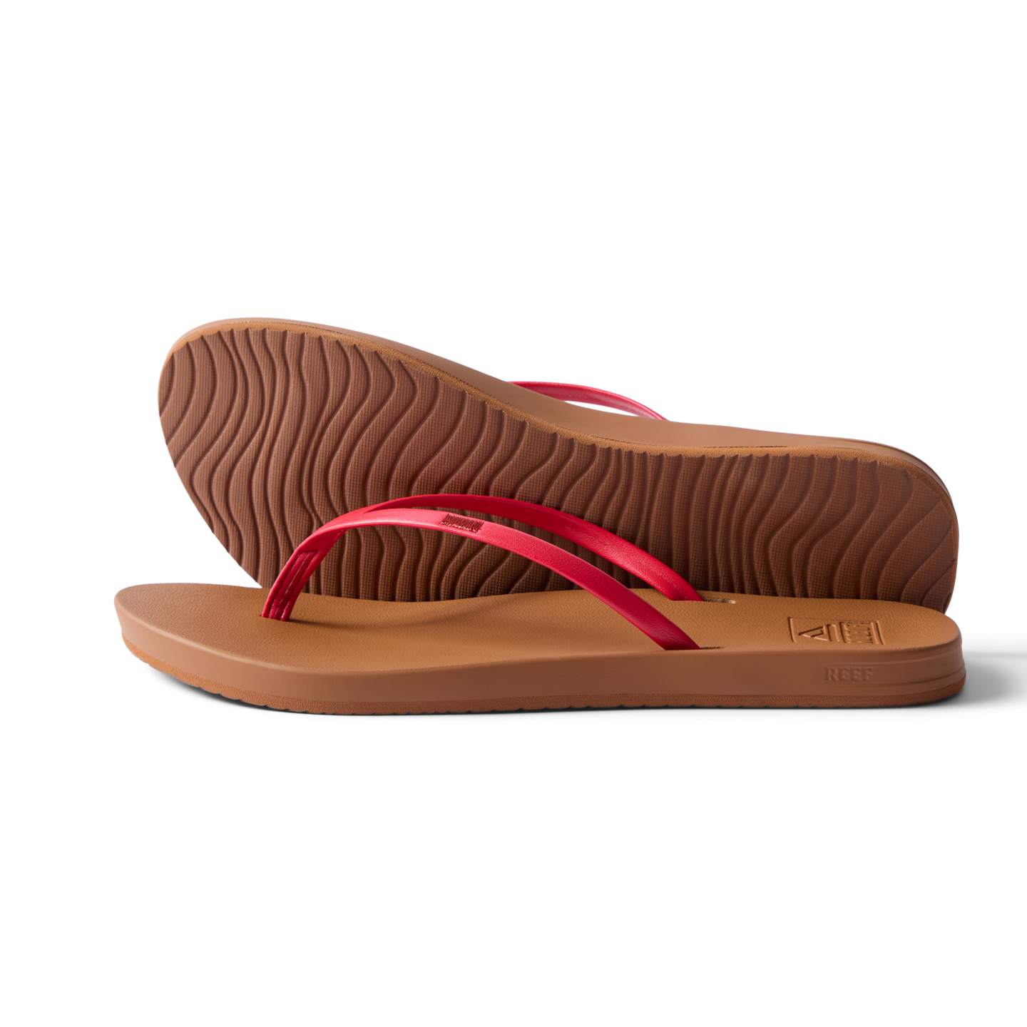 Pair of Cushion Slim women's sandals facing right, side and sole view, red straps, beach-inspired water-friendly design.