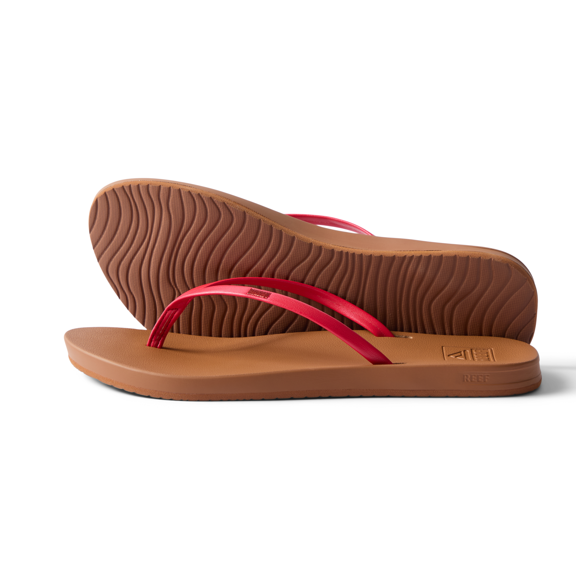 Pair of Cushion Slim women's sandals facing right, side and sole view, red straps, beach-inspired water-friendly design.