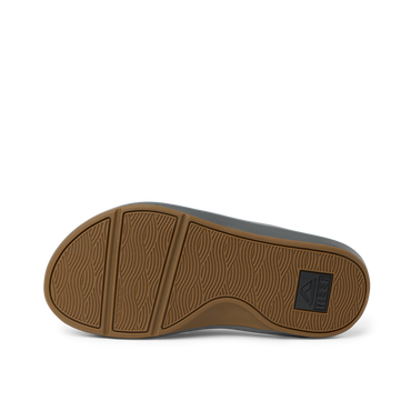 Cruiser men's shoe showing the brown rubber outsole facing up with wave-pattern tread, designed for comfort and durability.