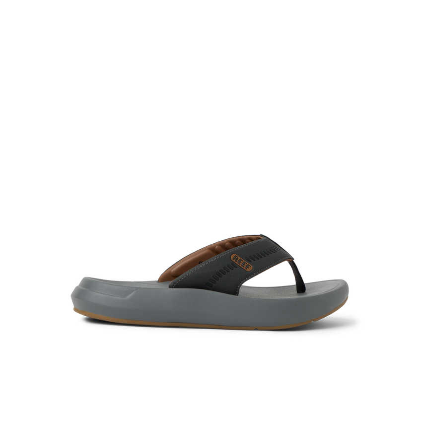 Cruiser men’s flip flop facing left, showing cushioned footbed and soft arch support in black and brown colors.