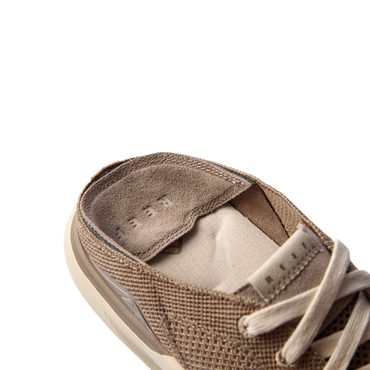 Close-up of the Neptune HT tan sneaker collar and padded tongue showing breathable knit upper and REEF label.