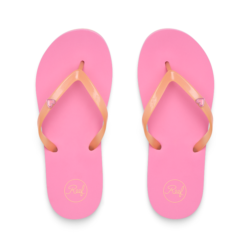 Kids Charming pink flip flops facing up, close-up of soft, water-friendly straps with heart charm and cushioned footbed.
