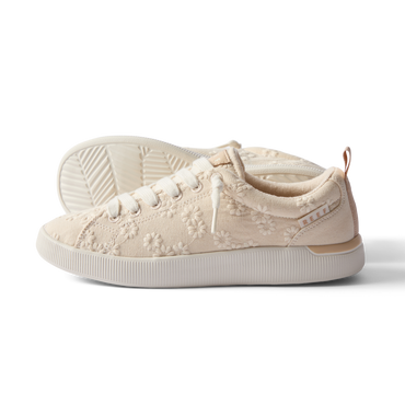 Side view of the left Neptune Alana sneaker for women with floral embroidery and enhanced arch support.