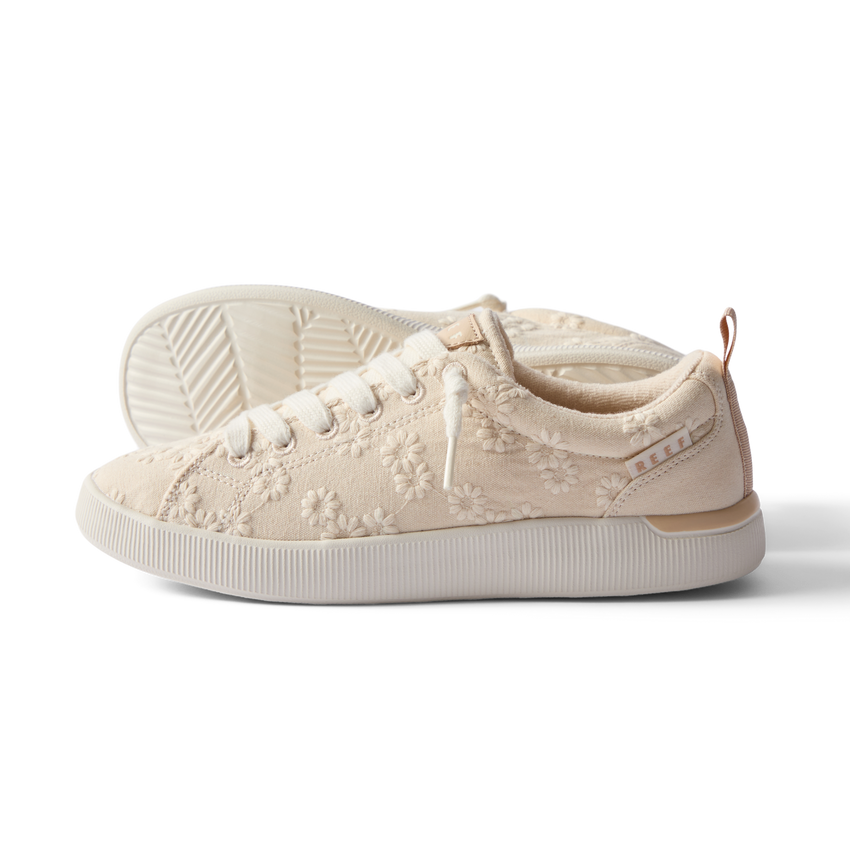 Side view of the left Neptune Alana sneaker for women with floral embroidery and enhanced arch support.
