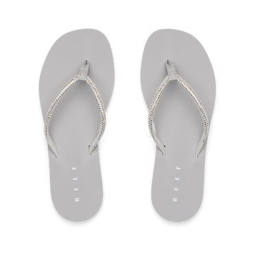 Bliss Bling Fling silver women's flip flops facing up, featuring surf-inspired comfort and soft cushioning for the beach.