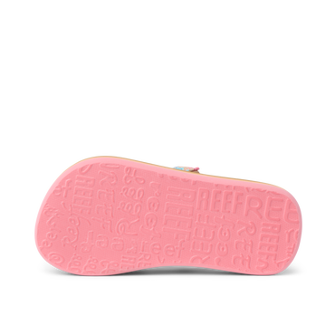 Little Ahi girls’ sandal showing bottom sole facing up with textured REEF branding in pink, lightweight comfort design.