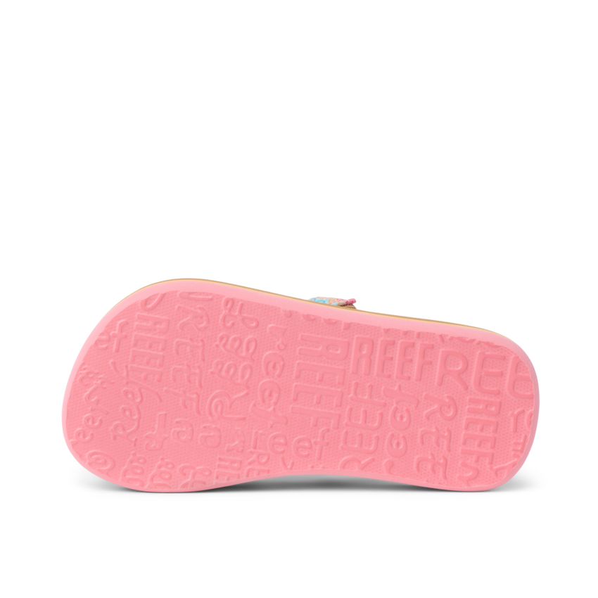 Little Ahi girls’ sandal showing bottom sole facing up with textured REEF branding in pink, lightweight comfort design.