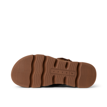 Vista Luxe Liah outsole facing up, brown rubber sole with wave-inspired tread for durable beach-ready traction and comfort