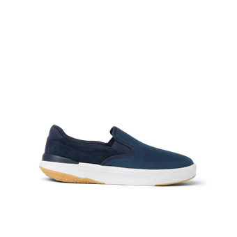 Side view of a navy blue slip-on sneaker with white sole and gum outsole, designed for comfort and beach lifestyle.