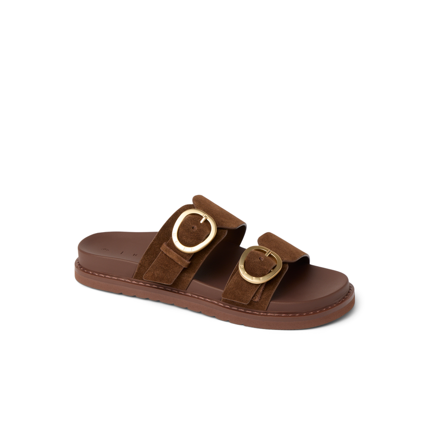 Vista Daphne slide sandal facing right, close-up of adjustable suede straps with gold buckles, featuring arch support.