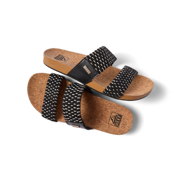 Pair of Cushion Vista women's sandals with black textile straps and cork footbed, right sandal facing left, top view close-up.