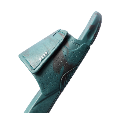 Fanning Slide H2O in deep teal marble facing right, close-up on front strap with breathable perforations and arch support.