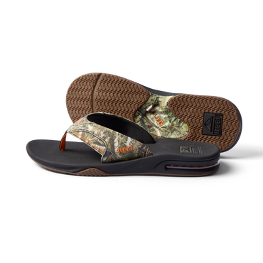 Fanning men's flip flop facing left, showing side and bottom with camo pattern, arch support, and cushioning