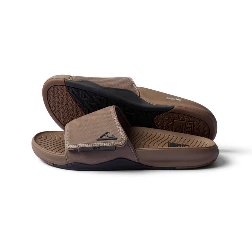 Phantom Slab men’s sandals in fossil black facing right showing footbed and top strap close-up, beach-inspired comfort footwear.