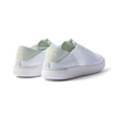 Reef Neptune women's sneakers showing rear and lateral sides facing left in white and dusty sage with cushioned arch support.