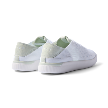 Reef Neptune women's sneakers showing rear and lateral sides facing left in white and dusty sage with cushioned arch support.