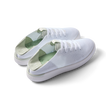 Pair of Reef Neptune shoes facing right, featuring white and dusty sage colors, knit material, and cushioned arch support.