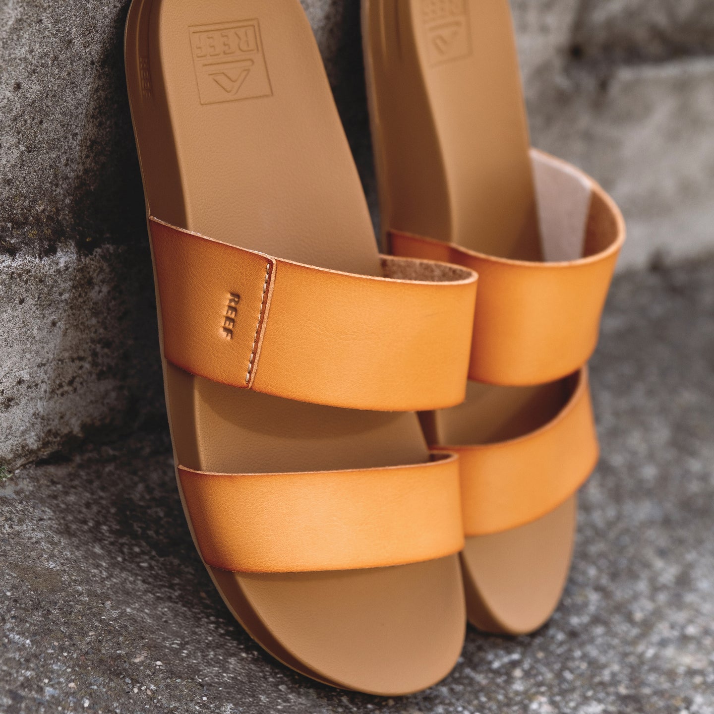 Pair of tan Cushion Vista sandals facing forward with dual straps and contoured cushioned footbed by REEF.