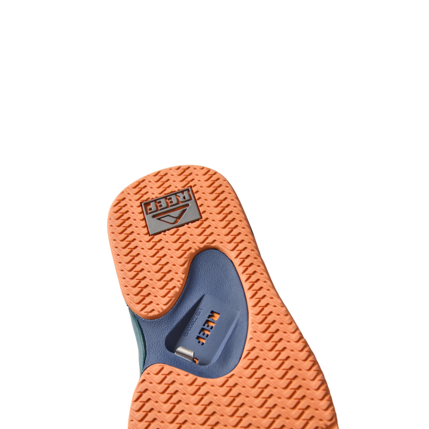 Fanning men's shoe showing orange sole with textured grip and blue arch support, surf-inspired comfort and durability.