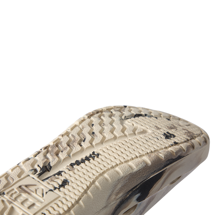 Glider close-up of the outsole facing right, showing textured traction and cushioned sole