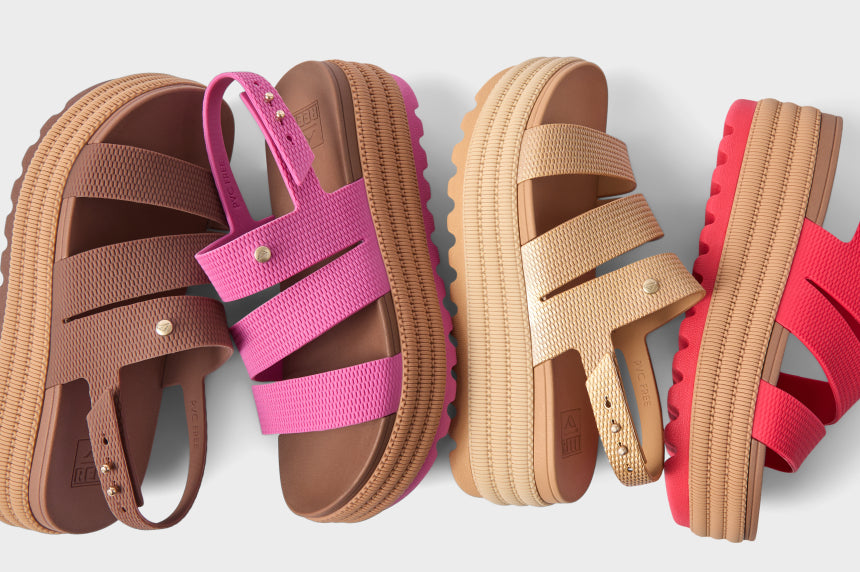 Top view of left-facing platform REEF sandals in brown, pink, beige, and red with cushioned footbeds and textured straps