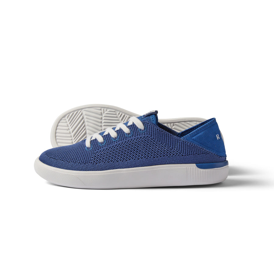 Kids Neptune navy sneaker facing left, close-up side and sole view, breathable knit with cushioned arch support