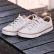 Lay Day Lite white REEF sneakers facing lower left on a wooden surface with cushioned comfort and arch support