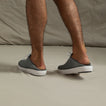 Rear view of men's Neptune Lido grey sneakers worn as slip-ons, showing soft cushioning and durable outsole for beach comfort.