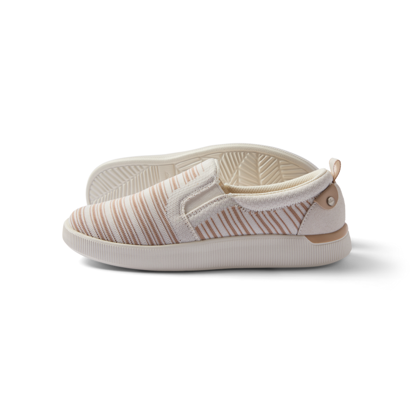 Neptune Elyse women's slip-on sneaker facing left, close-up side view with soft cushioning and arch support, beach-inspired design.