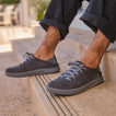 Neptune HT facing left on feet, men's black sneaker with REEFlex cushioning, anatomical arch support, lightweight mesh upper.