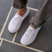 Top front view of white Neptune HT sneakers featuring cushioned, water-friendly design with arch support for all-day comfort.