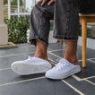 White Neptune HT shoes facing right, side and sole visible, beach-inspired with arch support and soft cushioning.