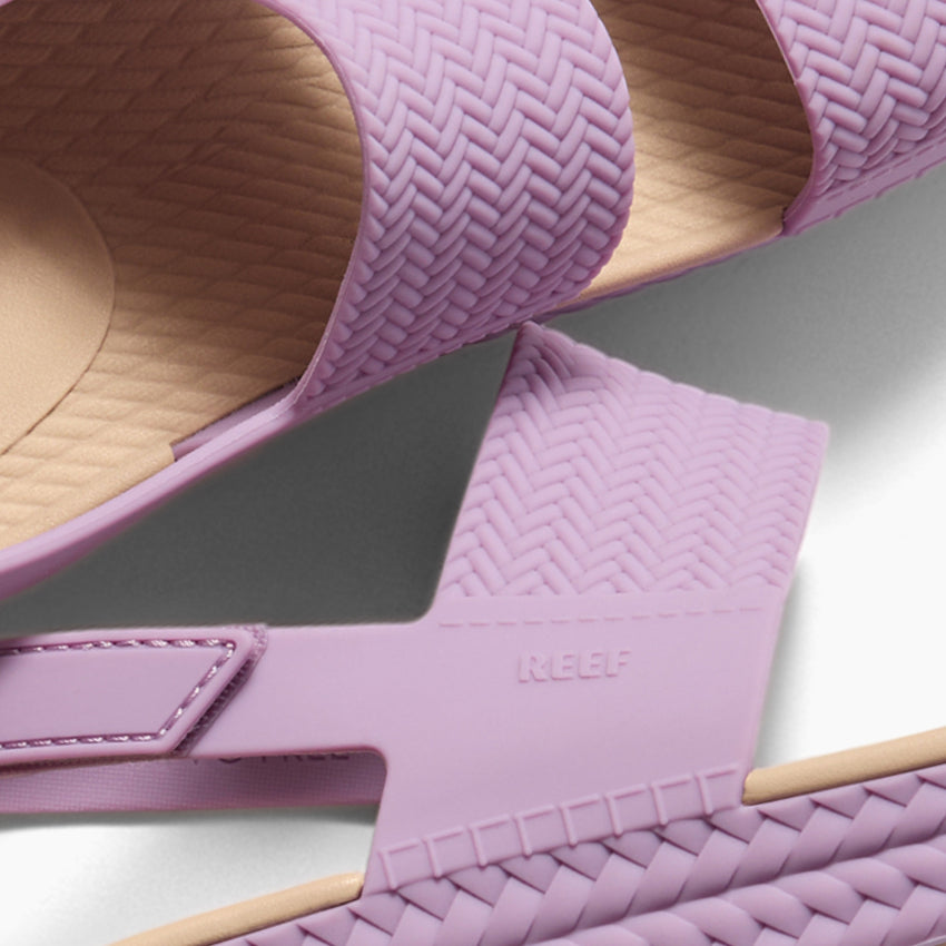 Close-up of Reef Water Vista women's sandals facing up, showing braided straps and cushioned footbed for comfort.