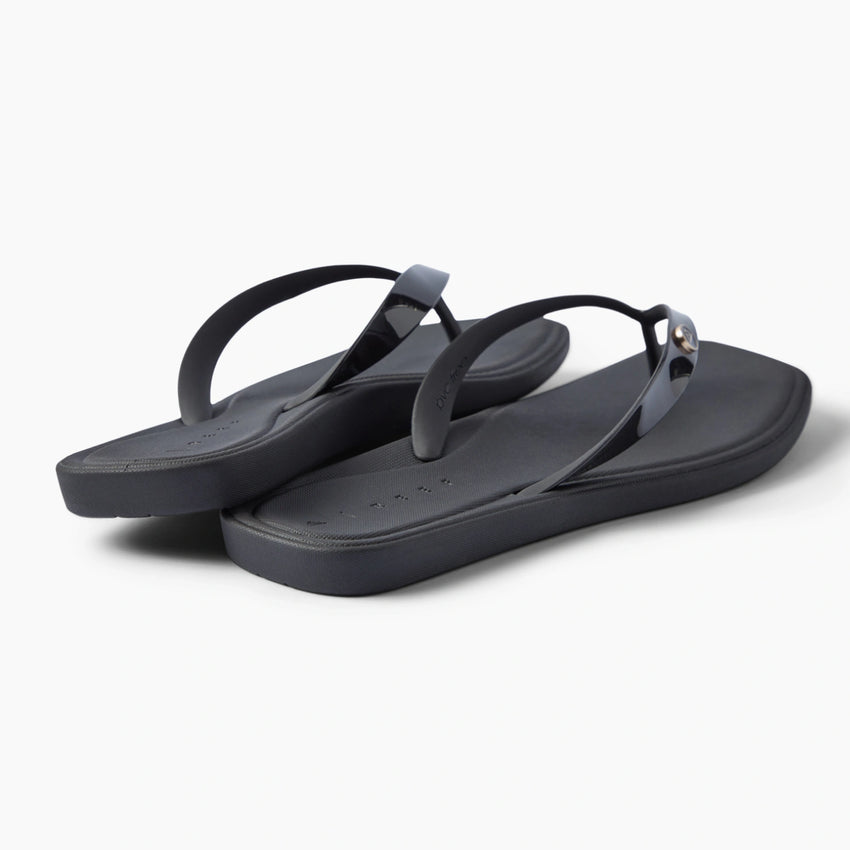 Solaye black flip flops facing right with sleek straps and cushioned footbeds for beach days