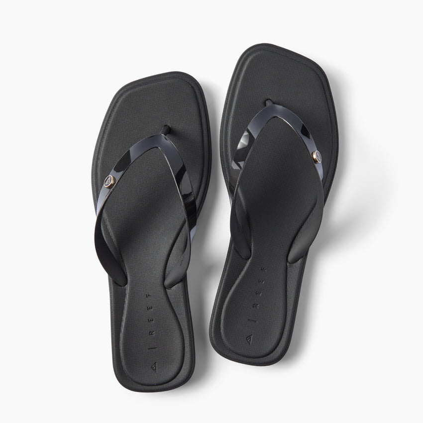 Solaye black square toe flip flops with glossy jelly straps toes facing upward