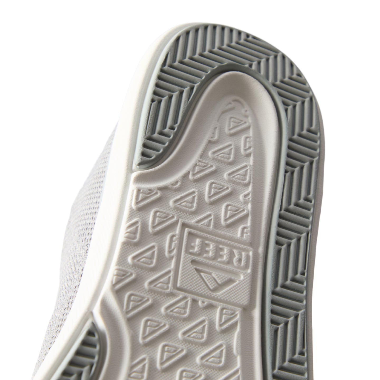 Neptune HT close-up of grey sneaker sole facing up with textured tread and REEF logo, designed for durable comfort and support