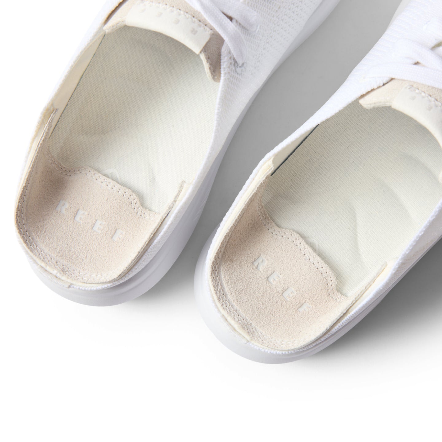 Top-down close-up of the heel area of the white Neptune HT sneaker showing cushioned footbed and arch support.