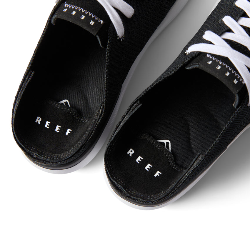 Close-up top view of the black Neptune HT shoes facing upward, showcasing REEF comfort and arch support.