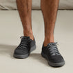 Neptune HT facing forward on feet, men's black sneaker with breathable knit upper, REEFlex cushioning, and arch support.