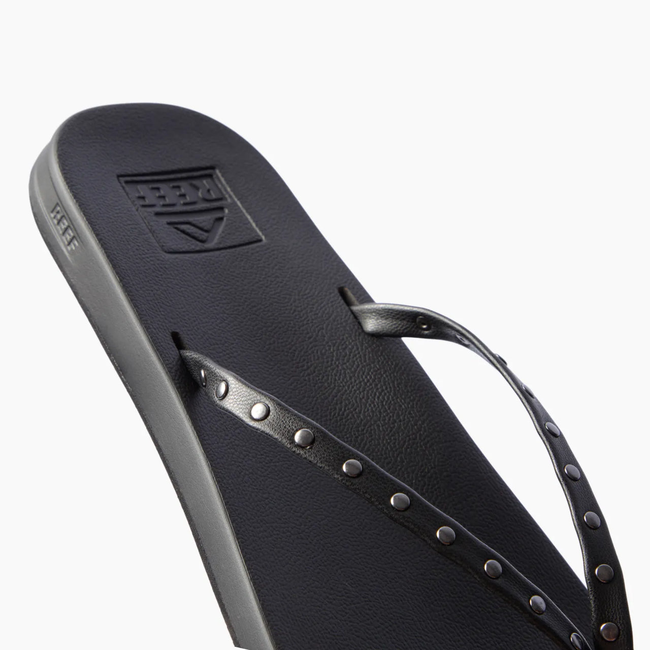 Cushion Slim Studs black women's sandal facing left, close-up of straps with slim studs, comfort-focused beach footwear.