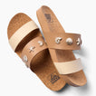 Cushion Vista women's sandals facing left with tan cork footbeds, cream and tan straps, and shell embellishments.