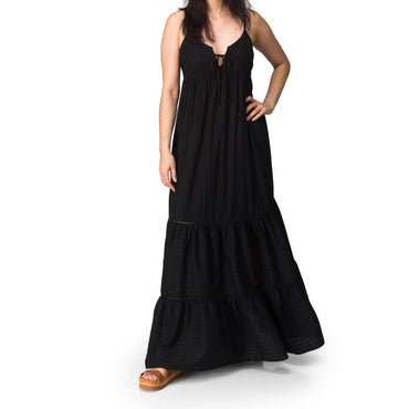 Woman wearing Yuni Maxi Dress with deep neckline and tie detail, paired with tan REEF sandals facing forward.