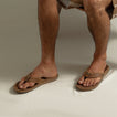 Leather Offshore sandals on adult male feet facing forward, showcasing soft-rebound cushioning and anatomical arch support.