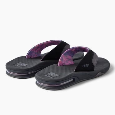 REEF Fanning black flip flops facing left with patterned straps and cushioned footbeds