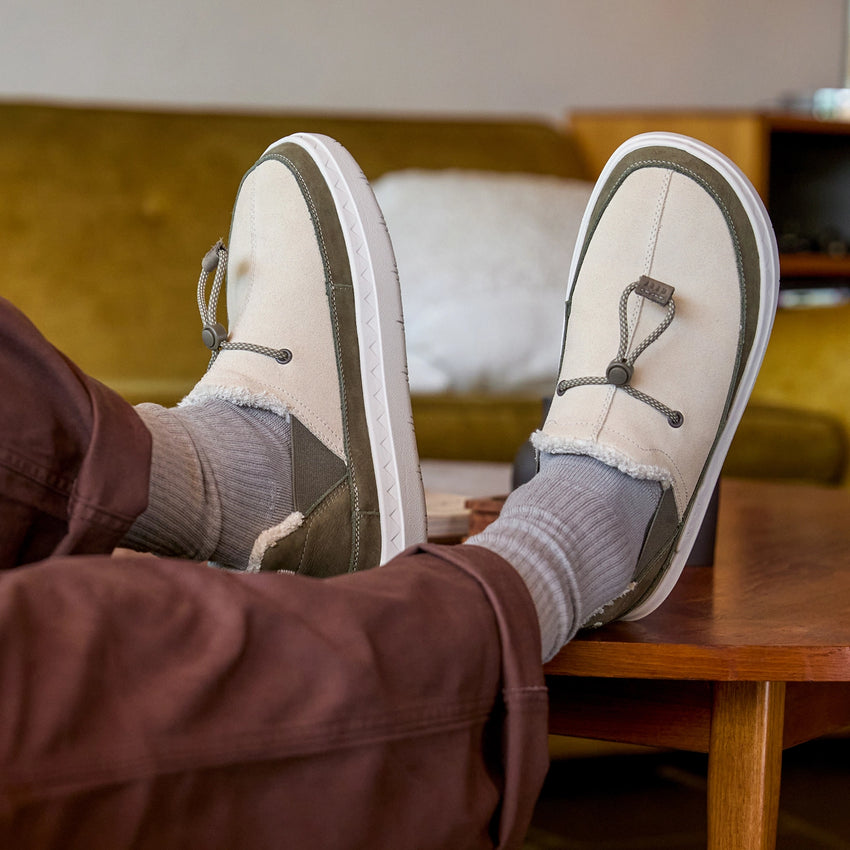 Rambler suede shoes worn with toes facing upward and outward cozy lining and cushioned soles visible