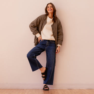 Woman wearing Vista Daphne black slide sandals facing forward with adjustable straps, styled for casual everyday comfort.