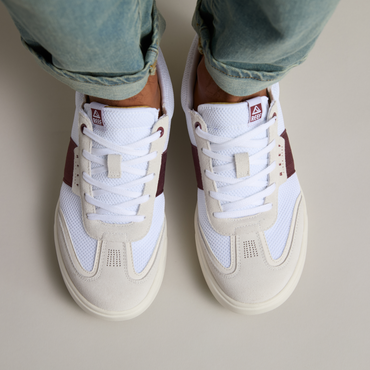 Top view of men's Triton sneakers in white with burgundy accents, featuring breathable mesh and cushioned comfort.