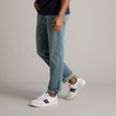 Triton shoes in white with burgundy stripe, right foot forward, showing side and top view, lightweight and comfortable design.