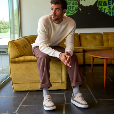 Rambler suede shoes facing forward on a seated man, featuring cushioned soles and a relaxed everyday style