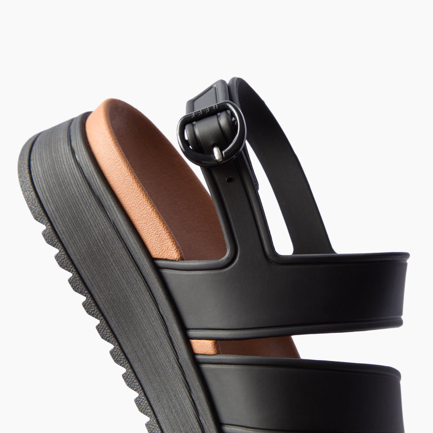 Vista Marbella black sandal facing right in close-up side view with buckle straps and textured platform sole